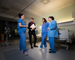 a group of people standing in a room playing a video game