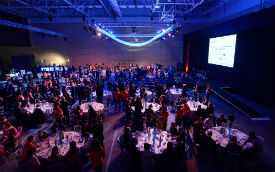 a group of people on a stage in front of a crowd