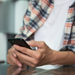 a man is using his cell phone