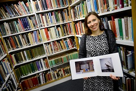 a person reading a book shelf filled with books