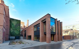 a large brick building with a store on the corner of a street