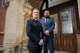 a man standing in front of a building