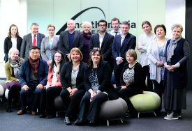a group of people standing in front of a crowd posing for the camera