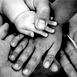 Front cover image for Northumbria University news Spring 2023 edition - hands coming together to show health and social equity