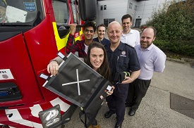 a group of people standing in front of a car