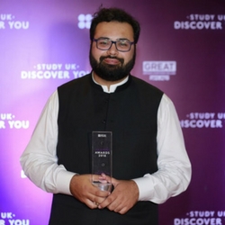 a man holding a sign posing for the camera
