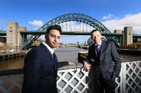 a man standing in front of a bridge
