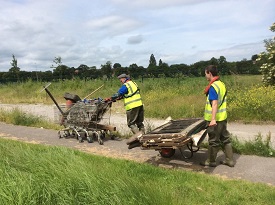 a man riding a motorcycle down a dirt road
