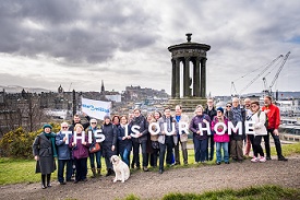 a group of people standing in front of a crowd posing for the camera