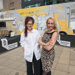 Sarah Munro, Director of BALTIC Centre for Contemporary Art stood next to Professor Katy Shaw, Director of Cultural Partnerships at Northumbria University, in front of The Travelling Gallery bus in the Quad on Northumbria University's campus.