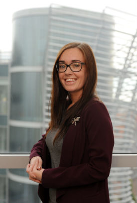 a woman standing in front of a window