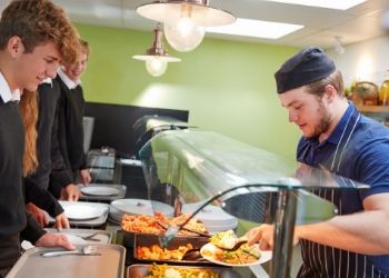 a man cooking in a kitchen preparing food