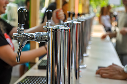 a person sitting at a table with wine glasses