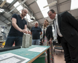 a group of people standing around a table