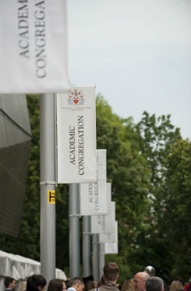 a group of people standing in front of a sign