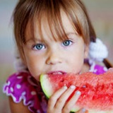 a little girl that is eating some food