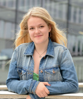a woman standing in front of a building