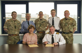 a group of people standing in front of a military uniform