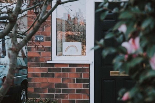 a person standing in front of a brick building