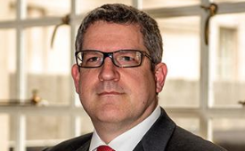 Andrew Parker wearing a suit and tie