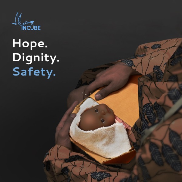 a hand holding a baby