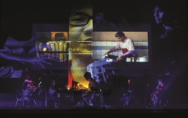 a man standing in front of a flat screen television