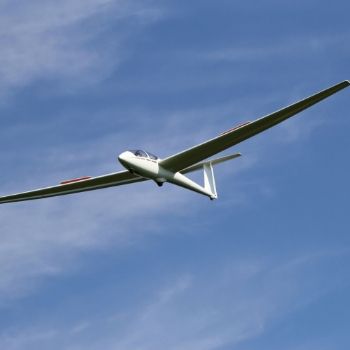 a large passenger jet flying through a cloudy blue sky