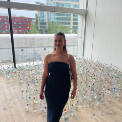 Alice Kershaw standing in front of a bottle display