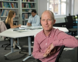 an older woman sitting at a table
