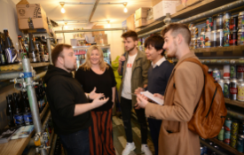 a group of people standing in front of a store