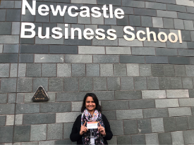 a person standing in front of a brick building