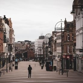 a group of people walking on a city street