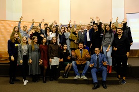 a group of people standing in front of a crowd posing for the camera