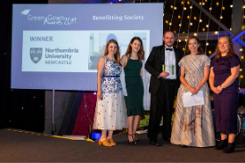 a group of people standing in front of a crowd posing for the camera