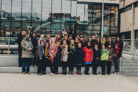 a group of people standing in front of a building