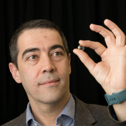 Professor Hamdi Torun pictured holding up a contact lens