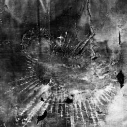 a black and white x-ray image of painting of the baby Jesus in a crib