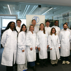 a group of people wearing white lab coats