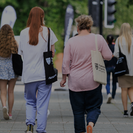 Image: student and their parent walking to Coach Lane Campus.