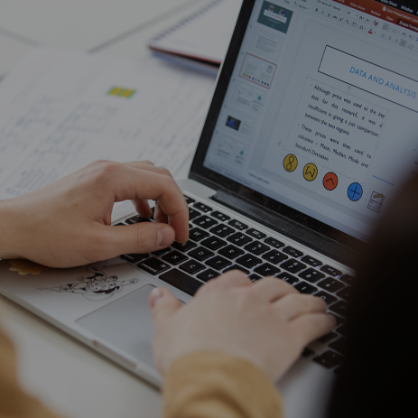 Image: student typing on a laptop.