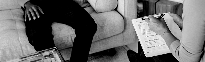 Taking notes, someone sat on a sofa