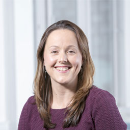 a woman standing in front of a window