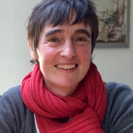 Lady with short hair wearing a red scarf