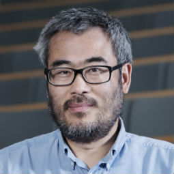 a man wearing glasses and looking at the camera