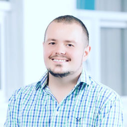 a young boy standing in front of a window
