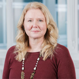 a woman standing in front of a window