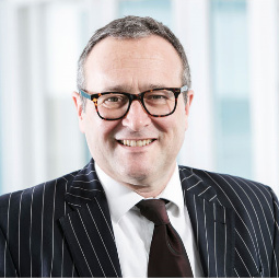 Michael Rowe wearing a suit and tie