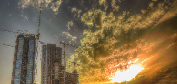 a view of a city with smoke coming out of it