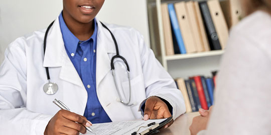 Female doctor writing notes