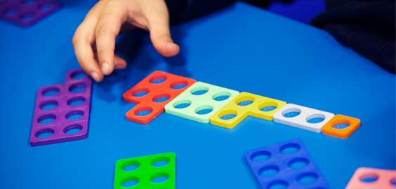 a hand holding a video game remote control